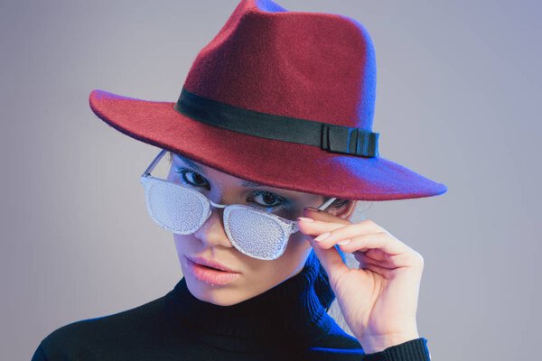 woman looking over sunglasses