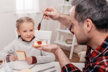 father and daughter having breakfast clipart