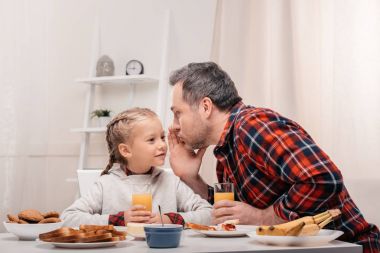 father and daughter having breakfast clipart