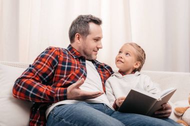father and daughter reading book clipart