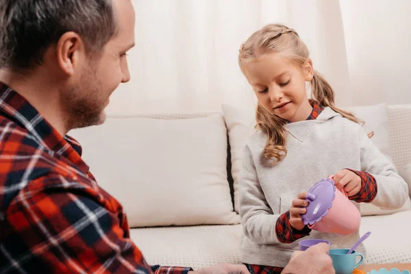 Child having tea party with father — Free Stock Photo