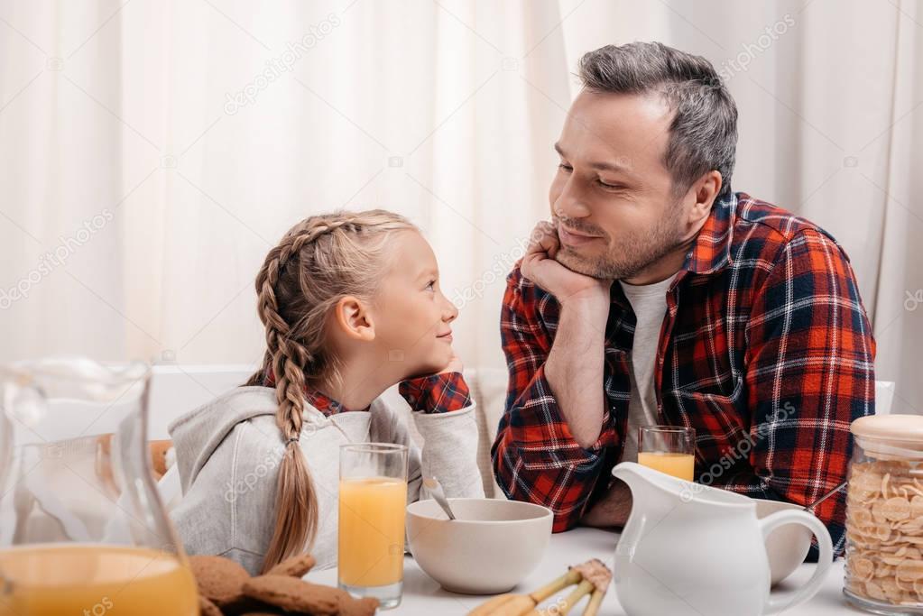 father and daughter having breakfast