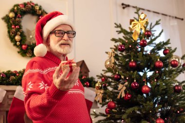 senior man with little gift at christmas clipart