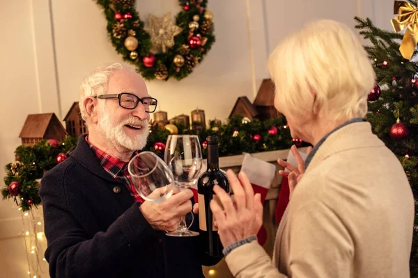 Pareja de ancianos con vino en Navidad — Foto de Stock