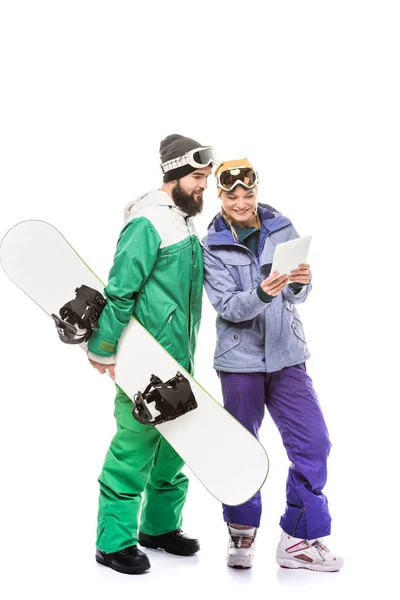 Couple of snowboarders with tablet — Stock Photo, Image