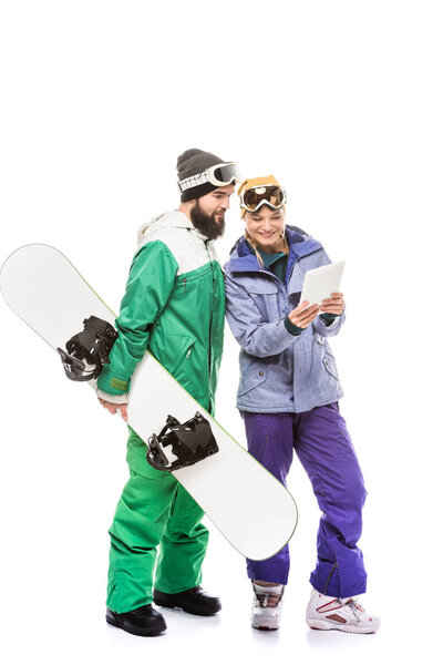 couple of snowboarders with tablet