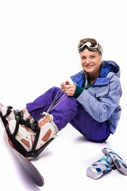 woman tying snowboard equipment clipart