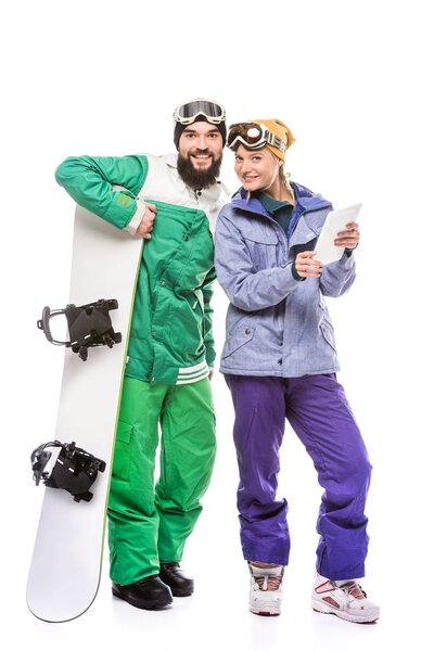 couple of snowboarders with tablet