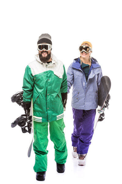 couple in snowboarding costumes with snowboards