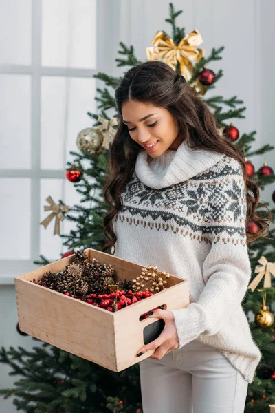 Woman with box of natural christmas decor — Stock Photo, Image