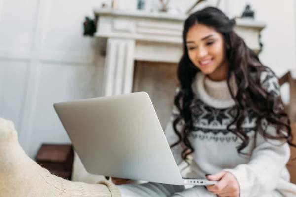 Woman in warm sweater working with laptop — Stock Photo, Image