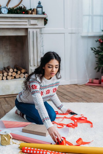 woman packing christmas gift