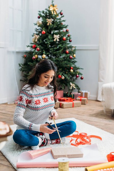 woman packing christmas gift