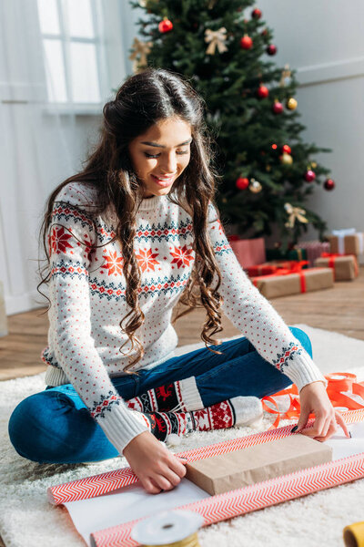 woman packing christmas gift