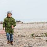 Boy running by seashore
