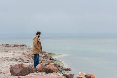 man standing on seashore clipart