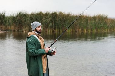 man fishing on lake clipart