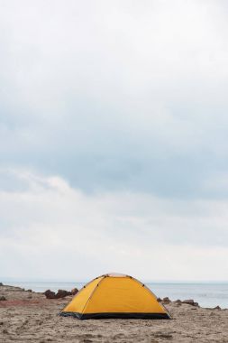 camping tent standing on seahore clipart