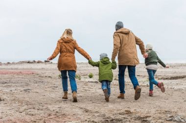 Aile elele ve seashore tarafından yürüyüş