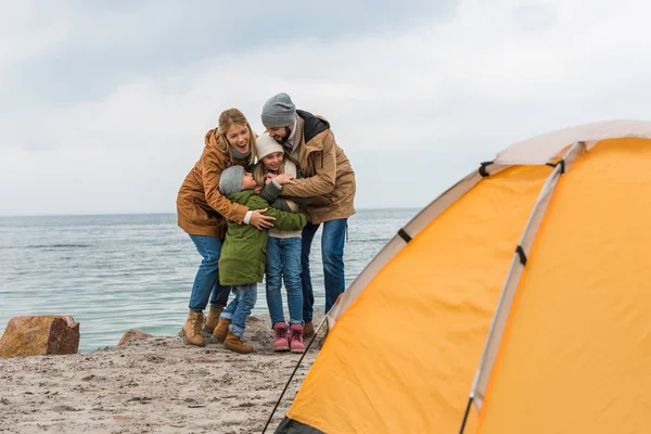 Familia feliz camping en la orilla del mar — Foto de Stock