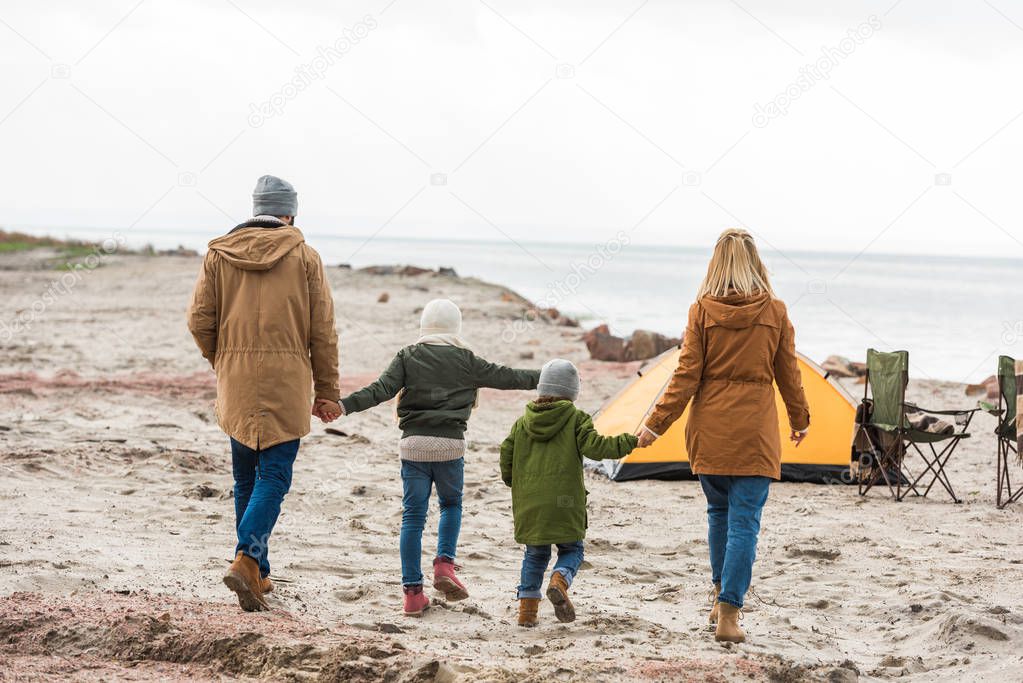 family having camp on seashore