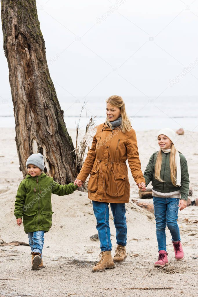 mother and kids on seashore