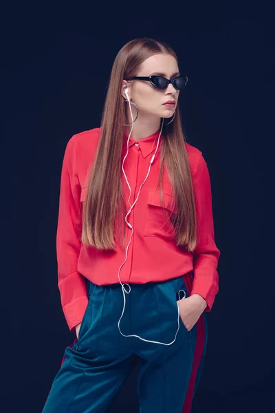 Woman in black sunglasses listening to music — Stock Photo, Image