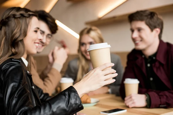 Girl holding paper cup of coffee — Stock Photo, Image