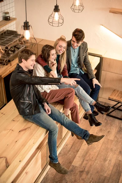 Friends sitting on bar counter — Stock Photo, Image