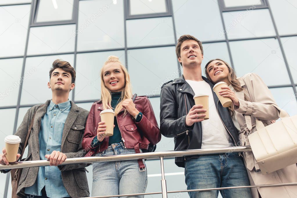 friends with disposable coffee cups 