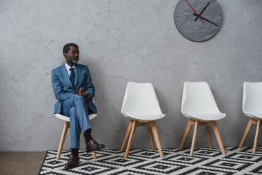 businessman sitting in waiting room  clipart