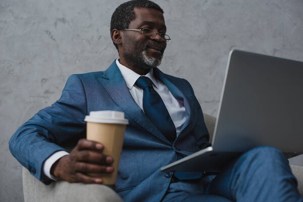 businessman sitting with laptop and coffee