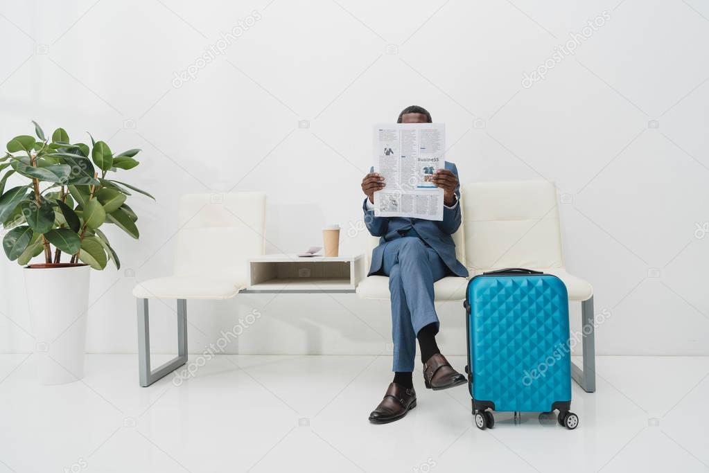 Businessman reading newspaper 