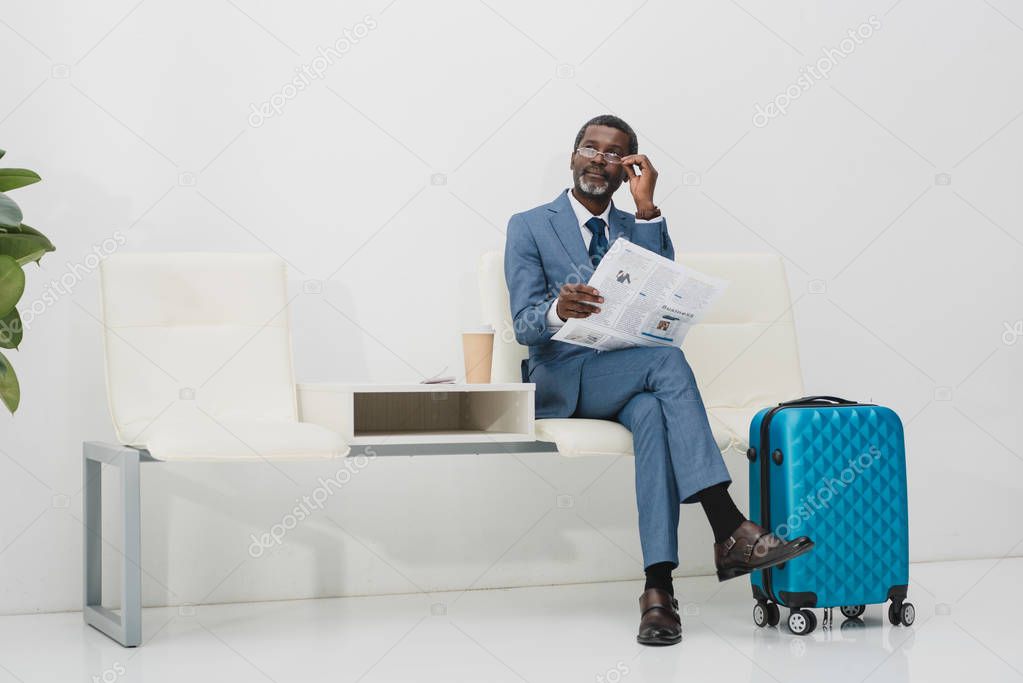 Businessman looking above glasses