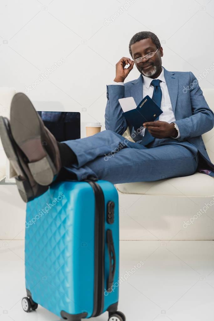 businessman checking departure time in ticket