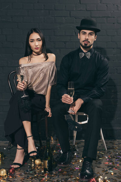 multicultural couple with glasses of champagne at party