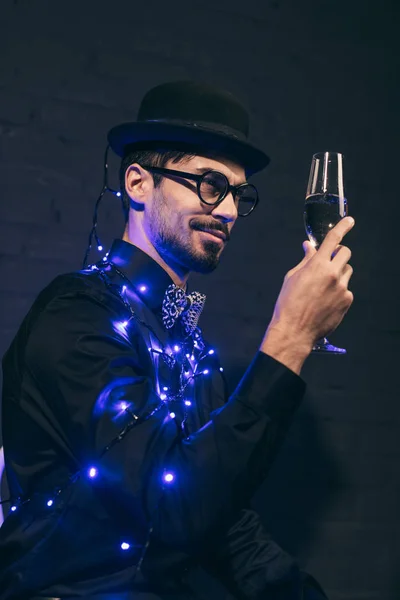 Man with champagne and christmas lights — Stock Photo, Image
