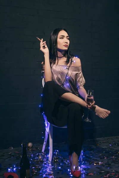 Asian woman with cigarette and champagne — Free Stock Photo