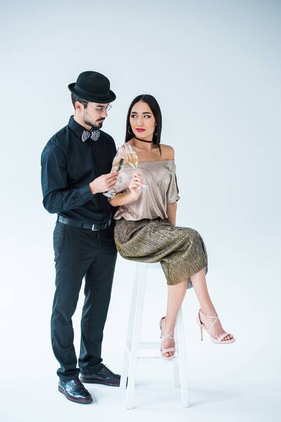 multicultural couple clinking glasses of champagne