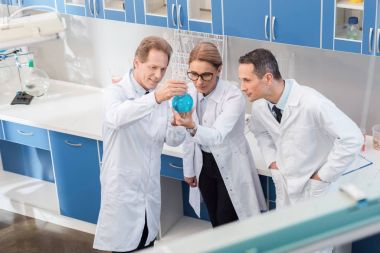 chemists examining reagent clipart