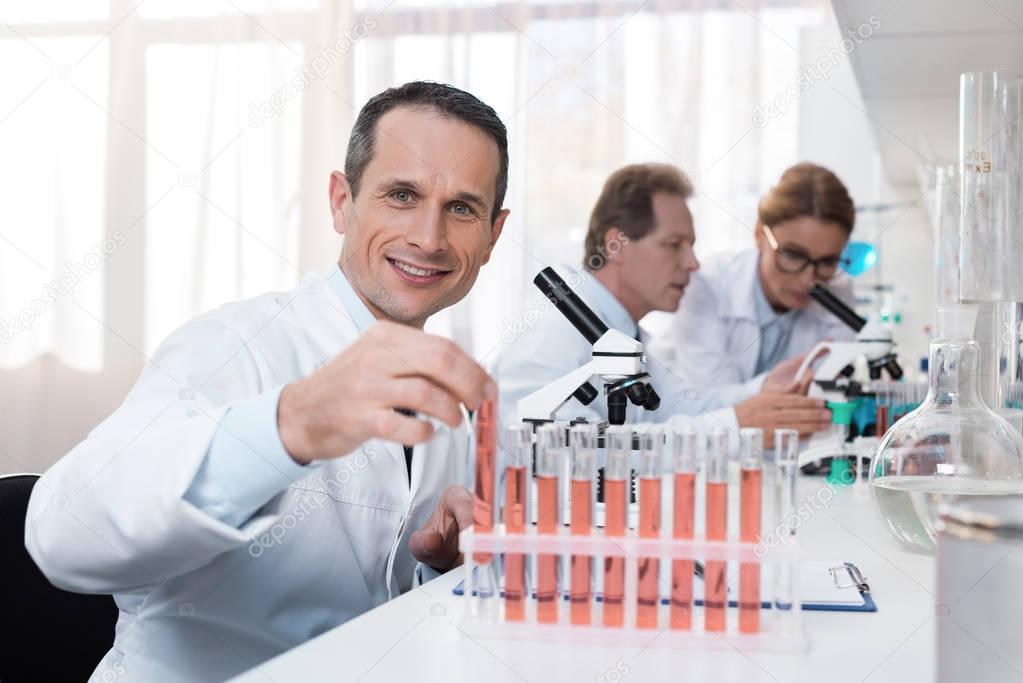 scientist holding test tube