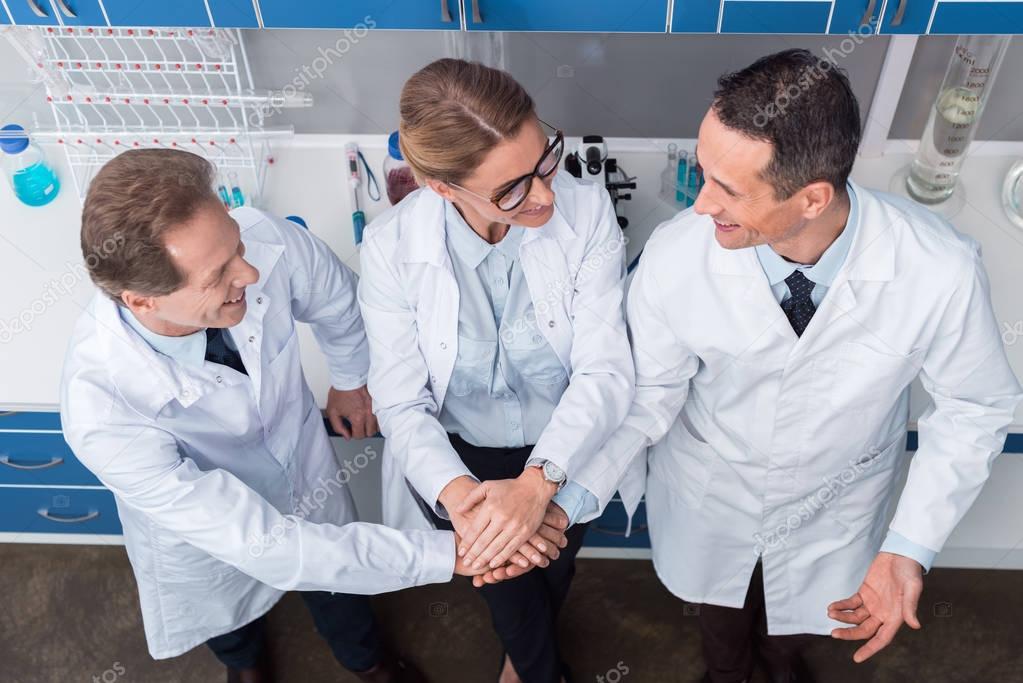 Scientists holding hands