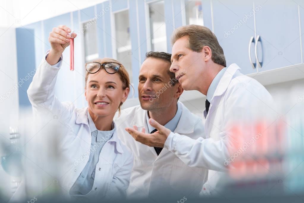 Scientists examining test tube