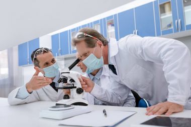 Scientists working with microscope clipart