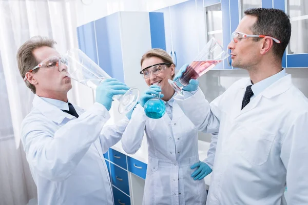 Ärzte täuschen vor, aus Reagenzgläsern zu trinken — Stockfoto