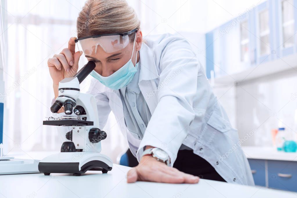 Scientist working with microscope  