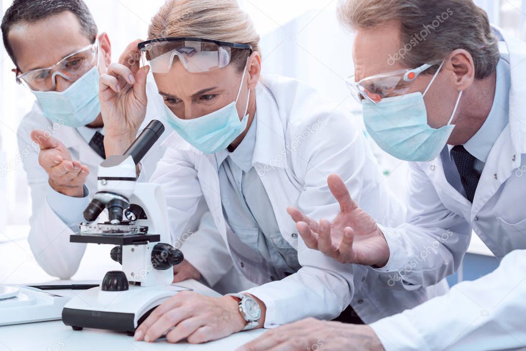 Doctors using microscope