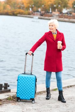 senior woman with suitcase clipart
