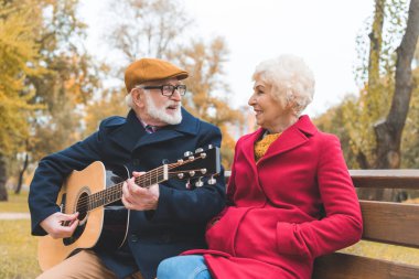 senior couple with acoustic guitar clipart