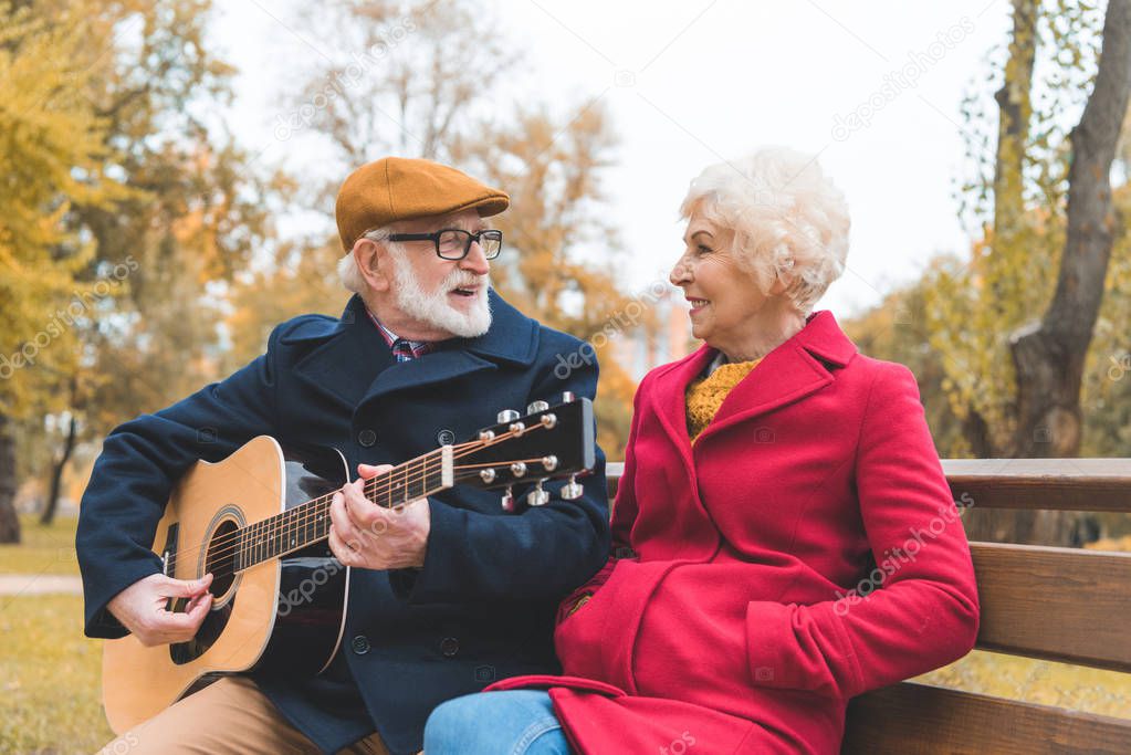 senior couple with acoustic guitar
